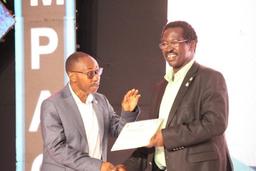 Rotarian-George-Francis-Iwa-right-ED-at-CAFOMI-receives-an-award-certificate-at-the-2025